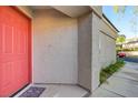 Close-up of a modern exterior showcasing a vibrant red front door and neutral stucco siding at 713 Chase Tree St, Las Vegas, NV 89144