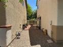 Side yard with gated access and mature landscaping offering privacy at 7226 Freedom Ring St, Las Vegas, NV 89148