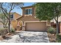 Charming two-story home featuring a two-car garage, desert landscaping, and a welcoming front entrance at 7407 Bakewell Ave, Las Vegas, NV 89179