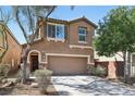 Charming two-story home featuring a two-car garage, desert landscaping, and a welcoming front entrance at 7407 Bakewell Ave, Las Vegas, NV 89179