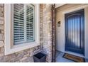 Close up of the home's entry door with stone and a Welcome mat at 7445 Mezzanine View Ave, Las Vegas, NV 89178