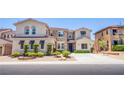 Inviting two-story home with decorative shutters and meticulously trimmed landscaping at 7445 Mezzanine View Ave, Las Vegas, NV 89178