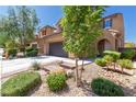 Charming two-story home featuring a desert landscape, a driveway, and a two car garage at 7652 Silver Baron Rd, Las Vegas, NV 89179