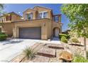 Charming two-story home featuring a desert landscape, a driveway, and a two car garage at 7652 Silver Baron Rd, Las Vegas, NV 89179