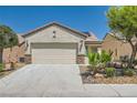 Charming single-story home featuring desert landscaping, a two-car garage, and a well-maintained front yard at 7717 Pine Warbler Way, North Las Vegas, NV 89084