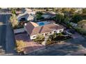 Expansive aerial view of a beautiful home with a pool, lush landscaping, and ample parking at 7745 Radcliff St, Las Vegas, NV 89123