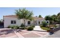 Inviting single-story home boasting a tile roof, manicured landscaping, and a patterned brick driveway for added curb appeal at 7745 Radcliff St, Las Vegas, NV 89123