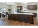 Spacious kitchen featuring custom wood cabinets, modern stainless steel appliances, and a large center island with a cooktop at 7745 Radcliff St, Las Vegas, NV 89123