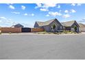 This well-maintained gray home sits behind a brick privacy wall and low maintenance desert landscaping at 8840 Harvest Sunset St, Las Vegas, NV 89113