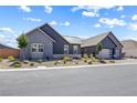 This gray single-Gathering home with low-maintenance landscaping is located on a paved street at 8840 Harvest Sunset St, Las Vegas, NV 89113