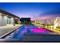 Enjoy a private pool with a built-in spa and beautifully landscaped backyard with accent lighting at 8840 Harvest Sunset St, Las Vegas, NV 89113