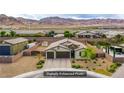 Expansive aerial view of a well-maintained property featuring a large driveway and desert landscaping at 10470 Irish Cliffs Ct, Las Vegas, NV 89149