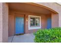 Charming front entrance with a bright blue door, window and neat landscaping at 10553 Pine Glen Ave # 101, Las Vegas, NV 89144