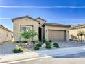 Attractive single-story home featuring a landscaped front yard and a convenient two-car garage at 146 Cabo Cruces Dr, Henderson, NV 89011