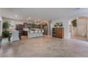 Inviting open floorplan with tile floors seamlessly connecting the kitchen, dining, and living areas at 151 Duckhook Ave, Las Vegas, NV 89148