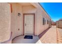 Inviting front entrance with a white door and brick-lined walkway, under a clear, bright blue sky at 1717 Dwayne Stedman Ave, Las Vegas, NV 89106