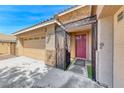 Close-up of the front entrance featuring a decorative gate, a maroon door, and stone accents at 1727 Sonoran Bluff Ave, Henderson, NV 89014