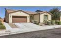 Attractive single-story home with desert landscaping, a two-car garage, and neutral exterior paint at 1792 Gentle Brook St, North Las Vegas, NV 89084