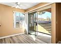 Bright bedroom featuring wood floors, large windows, and access to a private balcony at 2101 Sealion Dr # 108, Las Vegas, NV 89128