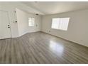 Open living room with sleek flooring, neutral walls, and bright windows at 2105 Kendall Hill Ave, Las Vegas, NV 89106