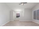 Open living room featuring sleek flooring, neutral paint, a ceiling fan, and ample natural light at 2305 W Horizon Ridge Pkwy # 524, Henderson, NV 89052
