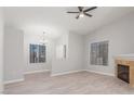Inviting living room boasts a cozy fireplace, neutral walls, wood-look floors, and a modern ceiling fan at 2305 W Horizon Ridge Pkwy # 524, Henderson, NV 89052