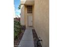 View of the front entrance with a white door, decorative window above, and a narrow walkway at 256 Camino Viejo St, Henderson, NV 89012