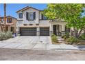Charming two-story home featuring a three-car garage, stone accents, and a well-maintained front yard at 2608 Prospector Mine Ave, North Las Vegas, NV 89031