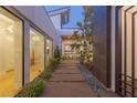 Stylish courtyard with pavers and decorative gravel leading to large windows and doors at 2610 Eldora Estates Ct, Las Vegas, NV 89117
