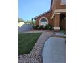 Charming home features a welcoming front yard with lush green grass, rock accents, and a well-maintained landscape at 2913 Domino Way, Las Vegas, NV 89117
