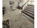 Spacious living room featuring marble tile flooring, modern decor, and a staircase at 2913 Domino Way, Las Vegas, NV 89117