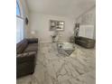 Bright living room with large windows, marble tile flooring, and stylish decor at 2913 Domino Way, Las Vegas, NV 89117