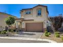 Two-story home with neutral stucco, tiled roof, and a two-car garage surrounded by manicured landscaping at 3002 Coveri Ct, Las Vegas, NV 89141