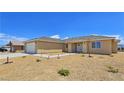 Beautiful single story home featuring manicured front yard and neutral colored exterior at 3016 Mount Charleston Dr, Pahrump, NV 89048
