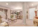 Elegant dining room with stylish furniture, including a glass-top table, decorative mirror, and ornate decorations at 312 Purple Passion Ave, North Las Vegas, NV 89032