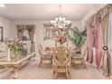 Formal dining area with a glass table, decorative chairs, and stylish window treatments at 312 Purple Passion Ave, North Las Vegas, NV 89032