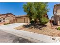 Inviting single-Gathering home with desert landscaping, a long driveway, and a two-car garage at 312 Purple Passion Ave, North Las Vegas, NV 89032