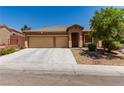 Attractive home with a well-maintained lawn, a spacious driveway, and a convenient two-car garage at 312 Purple Passion Ave, North Las Vegas, NV 89032