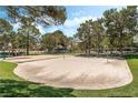 Recreation area with a sand volleyball court and a multi-sport court surrounded by mature trees at 3151 Soaring Gulls Dr # 1021, Las Vegas, NV 89128