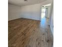 Open floor plan displaying wood-look floors and white walls, creating a bright and spacious feel at 3318 Covey Ln, Las Vegas, NV 89115