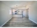 Open-concept living area with wood floors and a view of the modern kitchen at 3327 Erva St # 222, Las Vegas, NV 89117