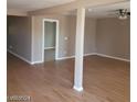 Open living room featuring hardwood floors, neutral walls, and bright lighting at 3439 Cox St, North Las Vegas, NV 89032