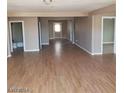Spacious living area with hardwood floors that connect to other rooms at 3439 Cox St, North Las Vegas, NV 89032