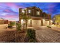 Charming two-story home with a brick driveway, two-car garage, and professionally landscaped front yard at 360 Rosefinch St, Henderson, NV 89012