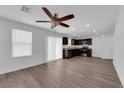 Bright and airy living area featuring sleek vinyl floors, contemporary ceiling fan, and natural light from large windows at 3677 Via El Monte Ave, Las Vegas, NV 89115
