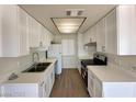 A modern kitchen featuring white cabinets, stainless steel appliances and bright countertops at 4230 Gannet Cir # 216, Las Vegas, NV 89103