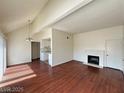 An inviting living room with wood floors, fireplace, and an open concept to the kitchen at 4230 Gannet Cir # 216, Las Vegas, NV 89103