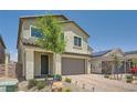 Charming two-story home with desert landscaping, a paver driveway and entry. A tree in the yard adds curb appeal at 4364 Contour Bend Ave, North Las Vegas, NV 89084