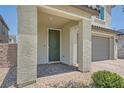 View of the front entrance with a covered porch and brick pavers, creating a welcoming entrance to the home at 4364 Contour Bend Ave, North Las Vegas, NV 89084
