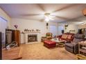 Cozy living room features a white brick fireplace, plush seating, and a ceiling fan for added comfort at 4539 Peardale Dr, Las Vegas, NV 89147